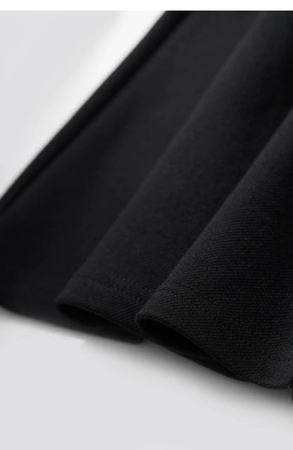 Close up of the hem of a black dress.
