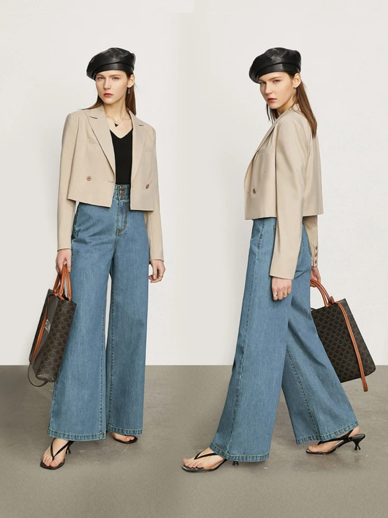 A stylish woman wearing a fitted black shirt with a pair of retro-inspired, wide leg jeans with a cinched waist design and a pair of sandals. She also has a black leather beret on and a cropped cream jacket to tie in the look.